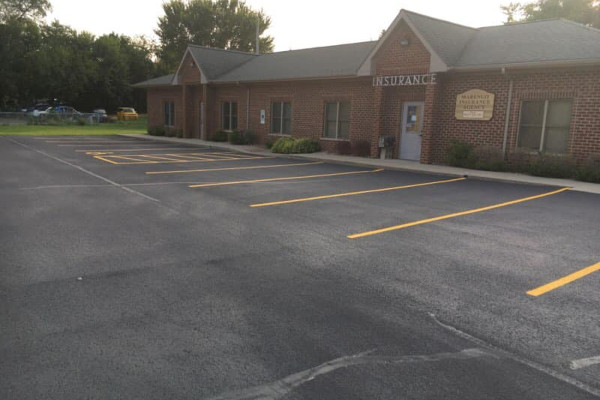 A finished parking lot sealcoating project by Pagni’s Sealcoating